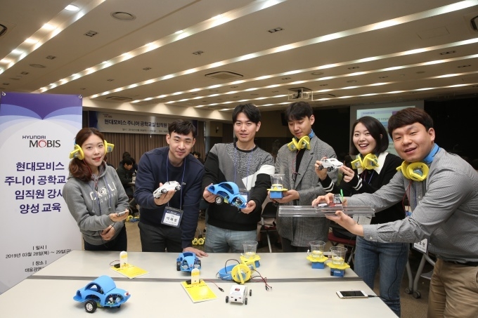 용인 대웅경영개발원에서 주니어공학교실 강사로 선발된 현대모비스 직원들이 한국공학한림원과 한양대 청소년 과학기술진흥센터 소속 강사진들의 설명을 들으며만든 과학 키트를 들어 보이고 있다.
