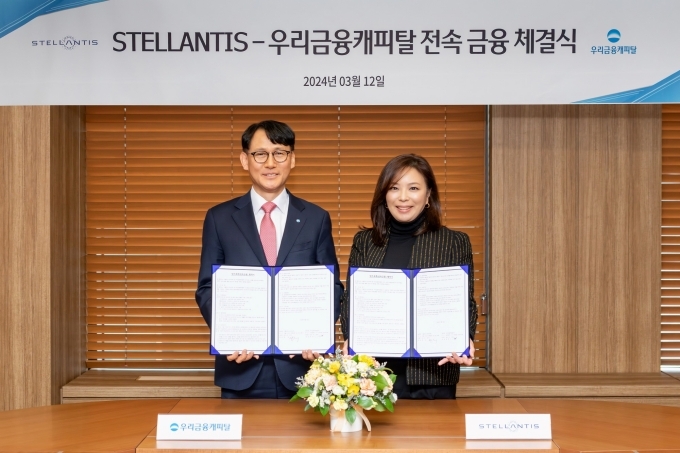우리금융캐피탈 정연기 대표이사(왼쪽)와 스텔란티스코리아 방실 대표이사(오른쪽)가 기념촬영을 하고 있다.