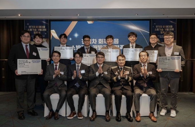 체결식에서 기념사진을 찍는 모습(뒷줄 좌측부터 시계방향으로 홍익대 서정환 교수, 중앙대 김동규 교수, 가천대 나성민 연구원, 한양대 오준호 교수, 한양대 김진용 교수, 서울과기대 김한상 교수, 홍익대 박상진 교수, 국립소방연구원 나용운 팀장, 전기차화재대응기술산학위원회 민경덕 위원장, 소방청 남화영 청장, 현대차·기아 양희원 사장, 한국자동차공학회 전병욱 회장, 현대차·기아 김동욱 부사장)