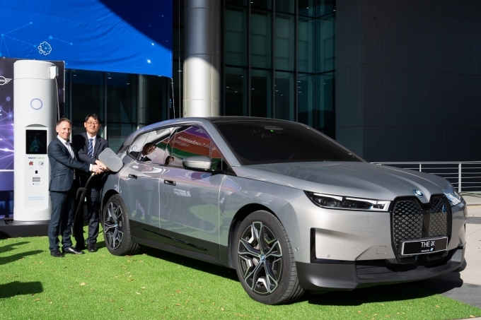 안드레아스 스툼 BMW 그룹 R&D 센터 코리아 총괄(왼쪽)과 이상원 한국전력 에너지신사업처장(오른쪽)이 BMW iX에 충전기를 연결하고 있다.