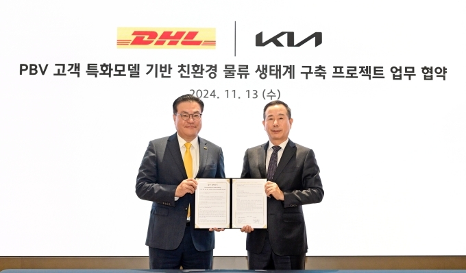 13일 진행된 업무협약식에서 DHL 코리아 한지헌 대표(왼쪽), 기아 국내사업본부장 정원정 부사장(오른쪽)이 협약서를 들고 기념촬영을 하고 있다
